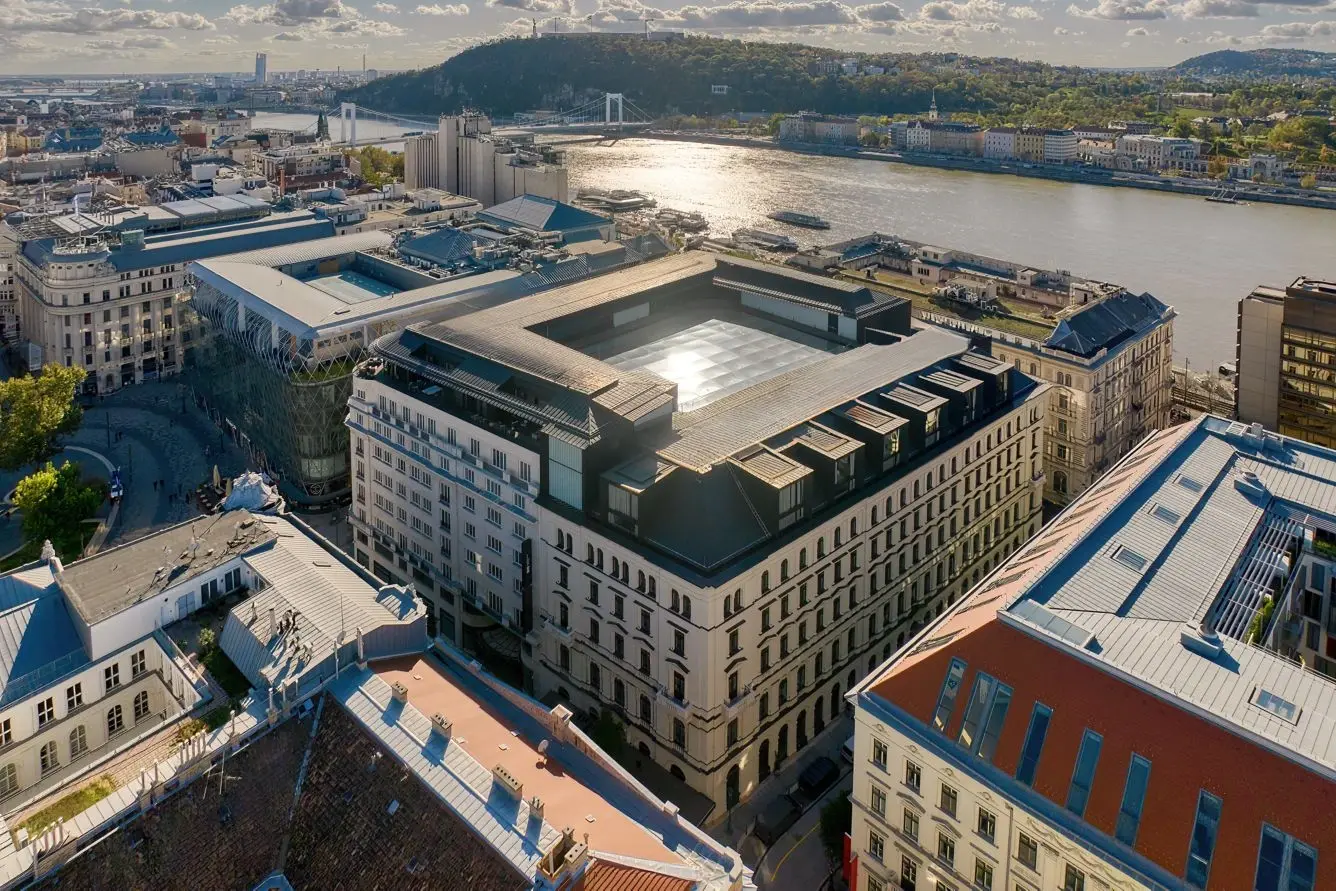 Aerial view of the Dorothea Hotel in Budapest with the Danube and Buda hills behind it